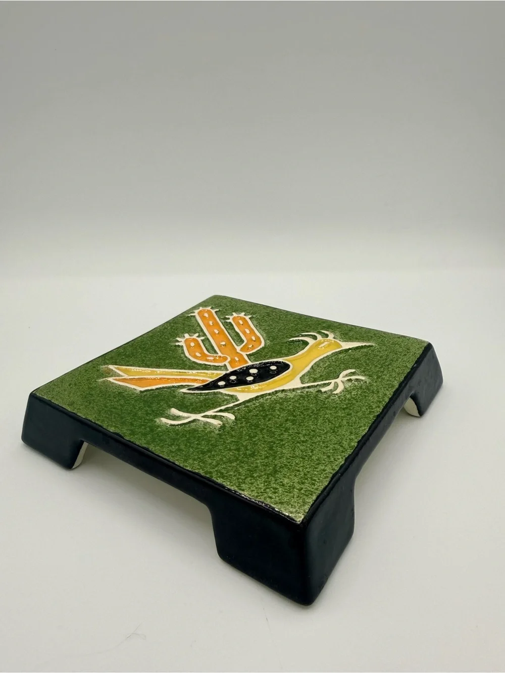 Vintage Legendware handcrafted ceramic roadrunner and cactus trivet.